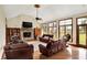 Open-concept living room boasts stone fireplace, hardwood floors, and an abundance of natural light at 893 W 500 S, Anderson, IN 46013