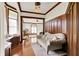 Elegant sitting room with wood paneling, hardwood floors, decorative windows, and comfortable seating at 893 W 500 S, Anderson, IN 46013