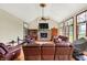 Inviting living room features vaulted ceilings, stone fireplace, hardwood floors, and large windows at 893 W 500 S, Anderson, IN 46013
