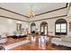 Open living and dining area featuring hardwood floors, chandelier, and arched windows with views at 893 W 500 S, Anderson, IN 46013