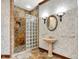 Elegant bathroom with glass shower, sconce lighting, pedestal sink, and decorative tile at 893 W 500 S, Anderson, IN 46013