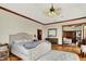 Inviting main bedroom with wood floors, decorative ceiling fan, and ensuite access at 893 W 500 S, Anderson, IN 46013