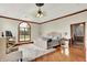 Spacious main bedroom with wood floors, large window, decorative ceiling fan, and ensuite access at 893 W 500 S, Anderson, IN 46013