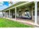 Covered back patio with columns, comfortable seating, and a relaxing hot tub at 893 W 500 S, Anderson, IN 46013