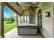 Covered patio with brick siding, columns, patterned concrete flooring, and a relaxing hot tub at 893 W 500 S, Anderson, IN 46013