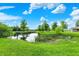 Beautiful pond features lush greenery, cattails, and mature trees at 893 W 500 S, Anderson, IN 46013