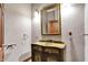 Elegant powder room featuring patterned wallpaper, sconce lighting, and designer vanity at 893 W 500 S, Anderson, IN 46013