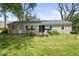 Large backyard with deck, sliding glass doors, and mature trees, perfect for outdoor enjoyment at 953 W Clinton St, Danville, IN 46122