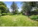 Expansive backyard featuring a shed, fire pit, and plenty of room for recreation at 953 W Clinton St, Danville, IN 46122