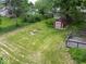 Spacious backyard with a red shed and firepit for outdoor gatherings at 953 W Clinton St, Danville, IN 46122
