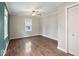 Comfortable bedroom with natural light, wood-look flooring, and neutral paint tones at 953 W Clinton St, Danville, IN 46122