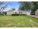 Charming single-story home with a well-manicured front lawn and attached garage at 953 W Clinton St, Danville, IN 46122