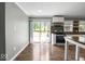 Bright kitchen featuring modern appliances, wood flooring, and sliding glass doors to the backyard deck at 953 W Clinton St, Danville, IN 46122