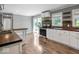 Well-lit kitchen boasts wooden countertops, white cabinetry, stainless appliances, and access to the outdoors at 953 W Clinton St, Danville, IN 46122