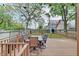 Back deck with seating area, adjacent to fenced yard with a playhouse at 1009 Broadway St, Indianapolis, IN 46202