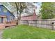 Spacious backyard featuring a manicured lawn, patio, and deck with outdoor seating at 1009 Broadway St, Indianapolis, IN 46202