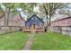 Wide view of the backyard featuring a deck, lawn, and privacy fence at 1009 Broadway St, Indianapolis, IN 46202