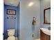 Stylish bathroom with blue walls, a classic vanity, and a toilet at 1009 Broadway St, Indianapolis, IN 46202