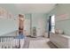 Bright Bedroom with soft aqua walls, offering a serene setting with a cozy rug and comfortable furniture at 1009 Broadway St, Indianapolis, IN 46202