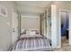 Comfortable bedroom with storage shelves and an adjacent bathroom at 1009 Broadway St, Indianapolis, IN 46202