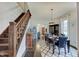 Cozy dining room with dark wood floors and staircase, perfect for Gathering dinners and entertaining guests at 1009 Broadway St, Indianapolis, IN 46202