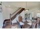 Spacious dining room highlighting a wooden staircase, and an open connection to the living area at 1009 Broadway St, Indianapolis, IN 46202