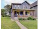 Charming two-story home with a welcoming front porch, brick accents, and well-manicured lawn at 1009 Broadway St, Indianapolis, IN 46202