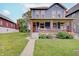 Charming two-story home with a welcoming front porch, brick accents, and well-manicured lawn at 1009 Broadway St, Indianapolis, IN 46202