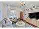 Cozy living room showcasing a plush sectional sofa, modern lighting, and warm wood floors at 1009 Broadway St, Indianapolis, IN 46202