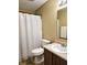Standard bathroom featuring a white shower curtain, toilet, and vanity with sink at 10836 Zimmerman Ln, Indianapolis, IN 46231