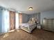 Cozy bedroom featuring a queen-sized bed, with natural light and a side table at 10836 Zimmerman Ln, Indianapolis, IN 46231