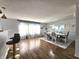 Open-concept dining area with decorative accents, stylish rug, hardwood floors, and an elegant dining set at 10836 Zimmerman Ln, Indianapolis, IN 46231
