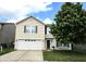Charming two-story home featuring a well-manicured front yard and an attached two-car garage at 10836 Zimmerman Ln, Indianapolis, IN 46231