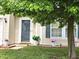 Inviting entryway features a storm door with decorative flower pots adding a warm touch to this home's facade at 10836 Zimmerman Ln, Indianapolis, IN 46231