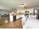 Bright kitchen featuring stainless steel appliances, white cabinets, and a breakfast table with chairs at 10836 Zimmerman Ln, Indianapolis, IN 46231