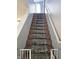 Carpeted staircase with baby gates for added safety at 10836 Zimmerman Ln, Indianapolis, IN 46231