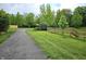 Community walking path through lush greenery, with a wooden bridge and landscaping at 10836 Zimmerman Ln, Indianapolis, IN 46231