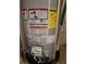 Close-up of a modern water heater with visible energy guide and safety labels at 10836 Zimmerman Ln, Indianapolis, IN 46231