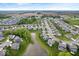 Scenic aerial of a community with charming homes, lush greenery, and a tranquil pond at 10993 Liberation Trce, Noblesville, IN 46060