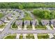 Beautiful aerial view of a neighborhood featuring well-maintained homes, green spaces, and a serene pond at 10993 Liberation Trce, Noblesville, IN 46060