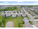 Aerial shot of a suburban neighborhood highlighting houses, spacious lawns, and a small pond at 10993 Liberation Trce, Noblesville, IN 46060