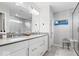 Modern bathroom featuring double sinks, sleek white cabinetry, and a glass-enclosed shower at 10993 Liberation Trce, Noblesville, IN 46060