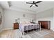 Spacious bedroom with trey ceiling, ceiling fan, gray wood floor and comfortable furnishings at 10993 Liberation Trce, Noblesville, IN 46060