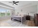 Primary bedroom features trey ceiling, fan, light gray wood flooring, and natural light at 10993 Liberation Trce, Noblesville, IN 46060