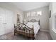 Bright bedroom featuring a decorative metal bed frame, natural light, and access to an en-suite bathroom at 10993 Liberation Trce, Noblesville, IN 46060