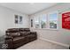 Cozy bonus room with a comfortable leather sofa and framed sports memorabilia for a relaxed atmosphere at 10993 Liberation Trce, Noblesville, IN 46060