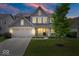 Charming two-story home featuring a well-manicured lawn and an attached two-car garage at 10993 Liberation Trce, Noblesville, IN 46060