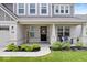 Inviting front porch with cozy seating and well-maintained landscaping at 10993 Liberation Trce, Noblesville, IN 46060