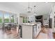 Bright kitchen features a large island, stainless appliances, open floor plan, and modern lighting at 10993 Liberation Trce, Noblesville, IN 46060
