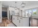 Open concept kitchen with stainless steel appliances, light cabinets and a large kitchen island at 10993 Liberation Trce, Noblesville, IN 46060